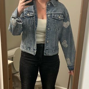 Denim jacket with bedazzled hearts on sleeve